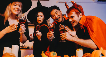 Friends enjoying a Halloween party at a bar making a toast