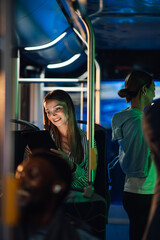 Young woman using tablet while riding bus at night © Zamrznuti tonovi