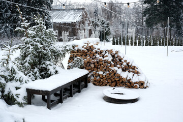 Winter wonderland with snow-covered woodpile and serene surroundings