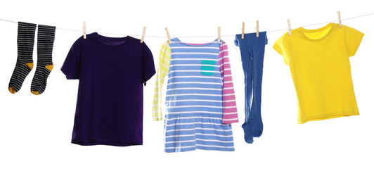 Different clothes drying while hanging on clothesline against white background