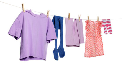 Different clothes drying while hanging on clothesline against white background