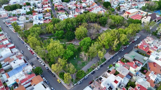 Church "Parroquia Sagrada Familia" in Queretaro, located among parks in an urban area aerial view