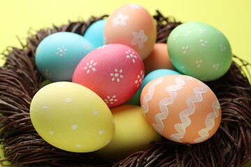 Obraz premium Beautiful decorated Easter eggs on yellow background, closeup