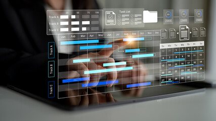 A businessman interacts with a digital tablet showcasing a Gantt chart, task list, and calendar, representing modern project management in a contemporary office environment. Gantry
