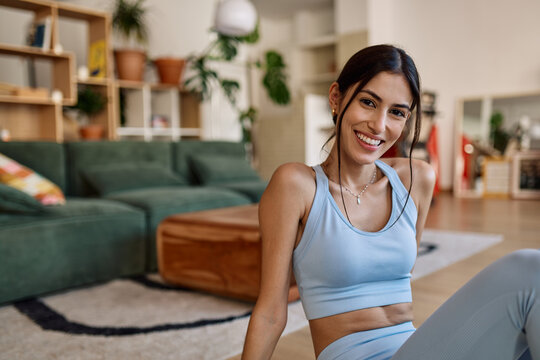 Portrait of a young latina woman posing with mat in sportswear prepering to exercise at home gym