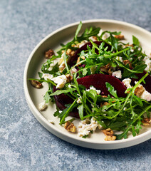 Healthy Beetroot Salad with feta cheese, walnuts and honey-lemon dressing. Copy space
