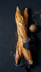 Fresh French Baguettes on dark slate background. Copy space. Top view