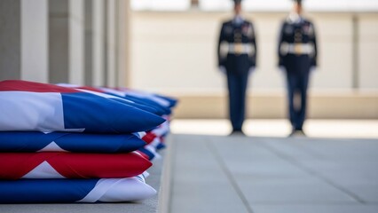 Folded american flags with soldiers standing guard with copy space