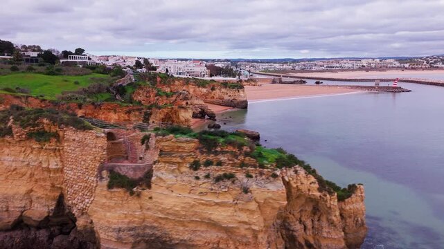 Aerial View of Ponte do Antigo Forte do Pinhao at Praia dos Estudantes in Lagos Algarve Portugal. 