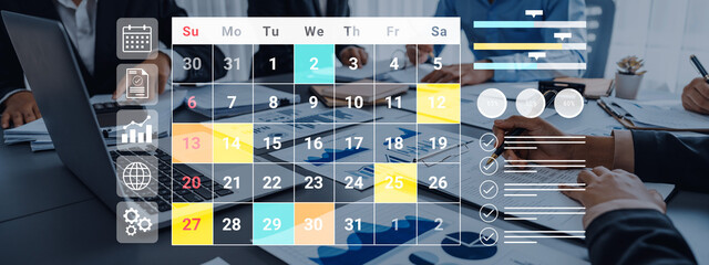 A focused team collaborates in a modern office, utilizing a calendar and charts to enhance project...