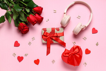 Gift boxes with headphones, rose flowers and music notes on pink background