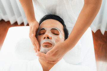 Serene modern daylight ambiance of spa salon, woman customer indulges in rejuvenating with facial...