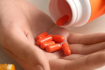 Female hands with vitamin C capsules, closeup