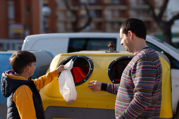Father and Son Recycling Plastic Outdoors