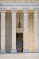 Naklejka premium Marble pillars highlight timeless architecture. Historic government building with massive columns. Classical facade with elegant stone pillars. Court house exterior with refined architecture.