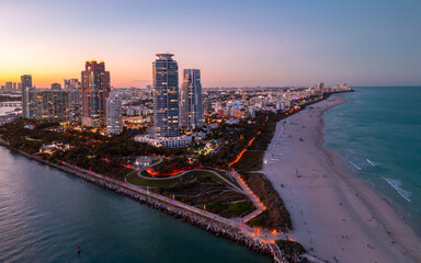 Fototapeta premium Miami pier with south pointe at night. Miami ocean shore at night. Miami shoreline. Panoramic Miami evening coastline.