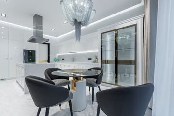 Magnificent kitchen interior in white. A showcase with glass doors. Stylish designer furniture.