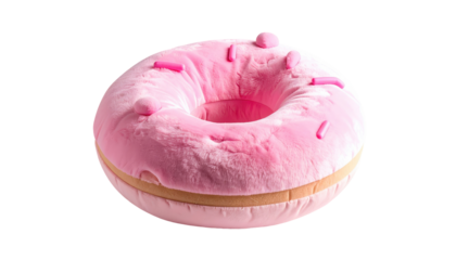 Soft, plush donut pillow with pink frosting and sprinkles, illuminated against black background