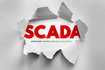 SCADA - Supervisory Control and Data Acquisition, depicted behind torn paper. It refers to systems used for monitoring and controlling industrial processes in real-time from centralized locations