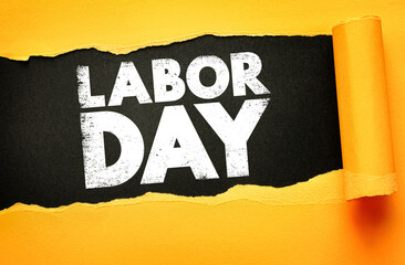 Labor Day text revealed on a torn paper background. Bold distressed letters emphasize the celebration of workers, employment, and labor rights, symbolizing strength, dedication, and unity