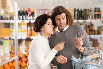 Married couple is looking for fresh produce together in a grocery supermarket