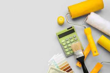 Composition with calculator and painting tools on grey background. Renovation budget concept