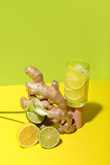 Glass of tasty cocktail with ginger root and citruses on color background