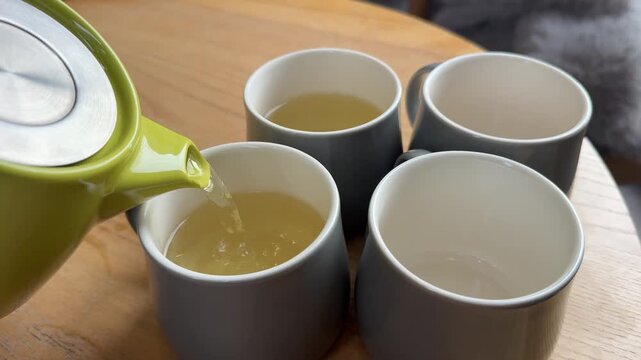 Vertical close up slow motion of a cup of hot coffee on the table of the glazed veranda. Steam rises up from ceramic mug with hot drink. Copy space morning mod background