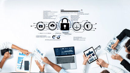 Business team analyzes cybersecurity data and strategies in a modern office setting with charts, graphs, and digital devices, emphasizing collaboration and security. Trope