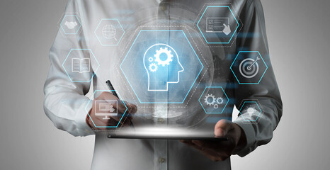 Head with gear and icons representing learning, digital training, and development process, showing skill growth for human or AI systems through knowledge or task optimization Vouch