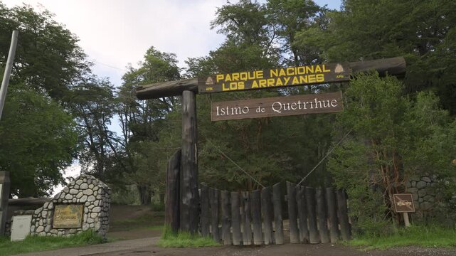 Man walking through the entrance of Los Arrayanes National Park at Istmo de Quetrihue with natural forest sounds and birds chirping. Villa La Angostura, Argentina - October 2025