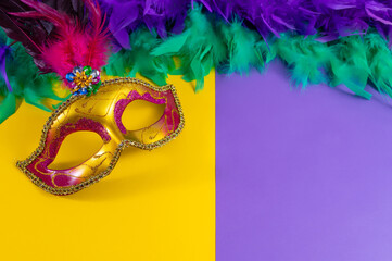Vibrant Mardi Gras background with mask, beads, and festive decorations