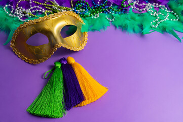 Vibrant Mardi Gras background with mask, beads, and festive decorations