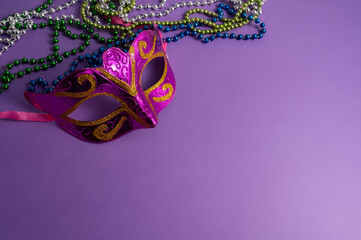 Vibrant Mardi Gras background with mask, beads, and festive decorations