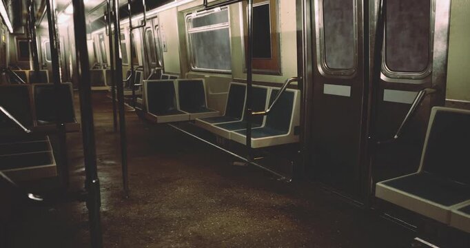 An empty subway car exhibits gloomy ambiance with dim lighting and wet floors. The seats, arranged neatly, suggest recent use but are currently unoccupied.