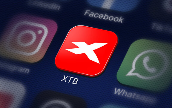 XTB Company logo on the smartphone