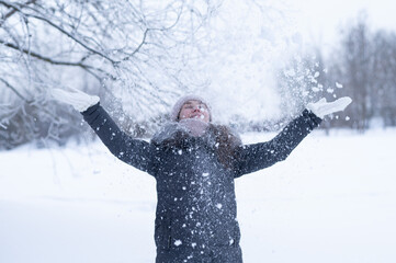 Joyful Woman Throwing Snow Up With Arms Wide Open