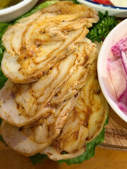 Vegan seitan roast- spicy wheat gluten as meat protein alternative, sliced on slate board