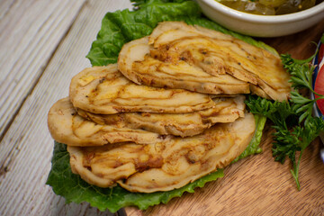 Vegan seitan roast- spicy wheat gluten as meat protein alternative, sliced on slate board