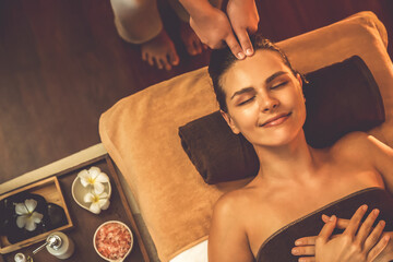 Caucasian woman enjoying relaxing anti-stress head massage and pampering facial beauty skin...