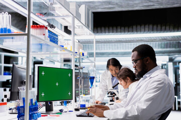 Green screen PC software used by research facility expert evaluating genetic markers. Medical lab technician studies DNA strand mapping with genomics analysis program on chroma key computer