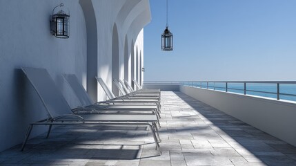 Modern terrace with lounge chairs overlooking ocean on a sunny day