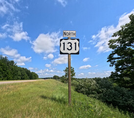 Michigan State Highway 131 (M-131) North Interstate sign situated on the right side of the road with room for copy space. M-131 serves as a transportation route from southern MI up through Petoskey.