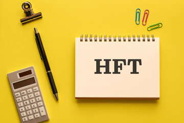 There is notebook with the word HFT. It is an abbreviation for High Frequency Trade as eye-catching image.