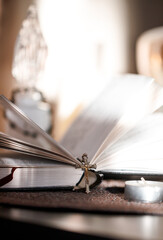 Open Catholic Bible and candle on a quiet table