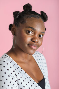 confident Young black woman posing in studio with bantu knots