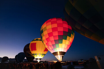 Hot air balloons glowing during the Dawn Patrol at Albuquerque Balloon Fiesta