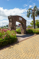 Herries stone arch and gardens on The Strand looking through and toward waterfront vertical composition.