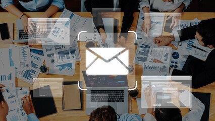 A dynamic office scene showing a diverse team collaborating on business strategies. Graphs, charts, and a laptop illustrate modern digital communication and analysis. Raster