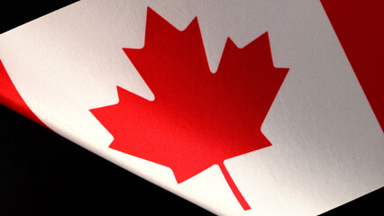 Close-up of the canadian flag with vibrant colors and textile texture.